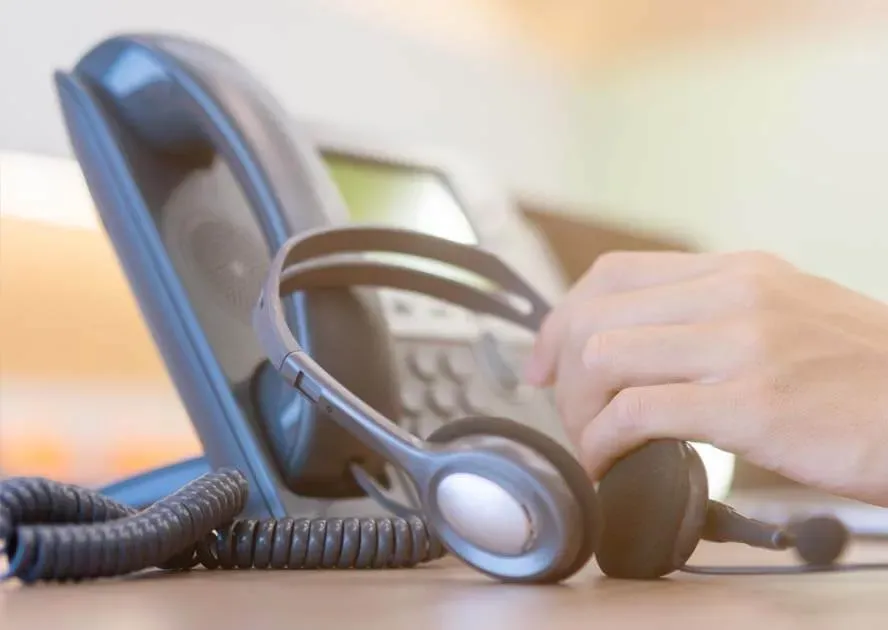 LG office handset next to a wireless headset