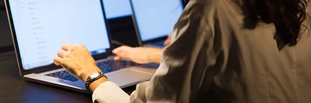 Woman typing on laptop at desk
