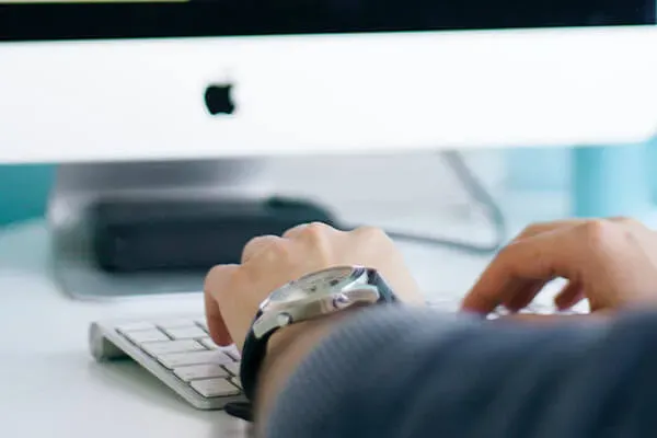 Person typing on a wireless keyboard
