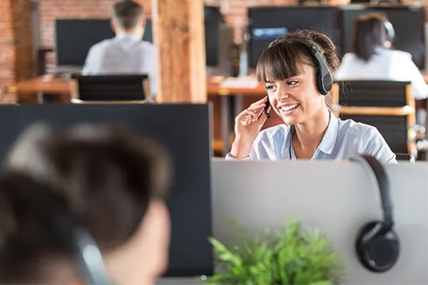 Woman smiling while moving headset microphone