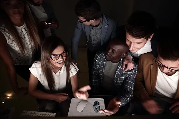 Group of people smiling while talking to one another