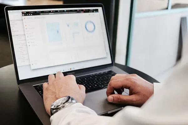 Man looking at data on laptop
