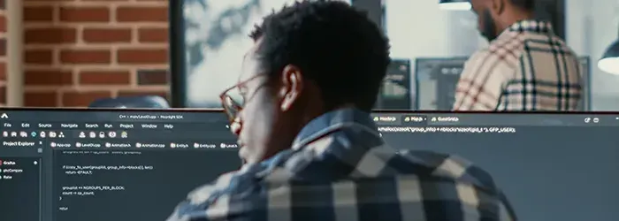 Man looking to his left with two monitors