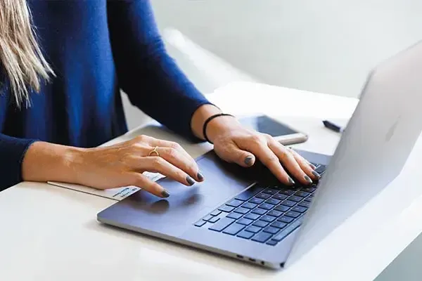 Woman working on a laptop at her desk