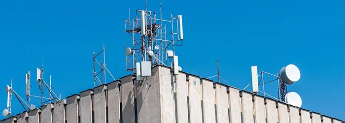 Collection of satellites and aerials on roof of building