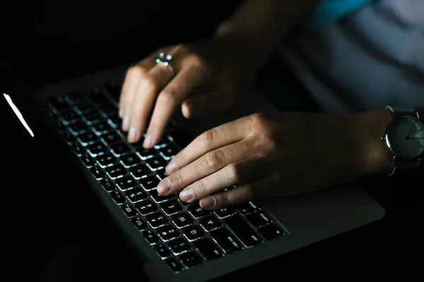 Person typing on laptop