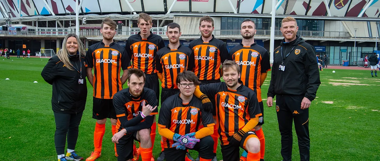 Group of male footballers with their coaches
