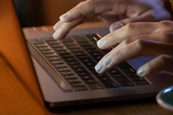 Person typing on laptop
