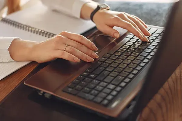 Woman typing on laptop