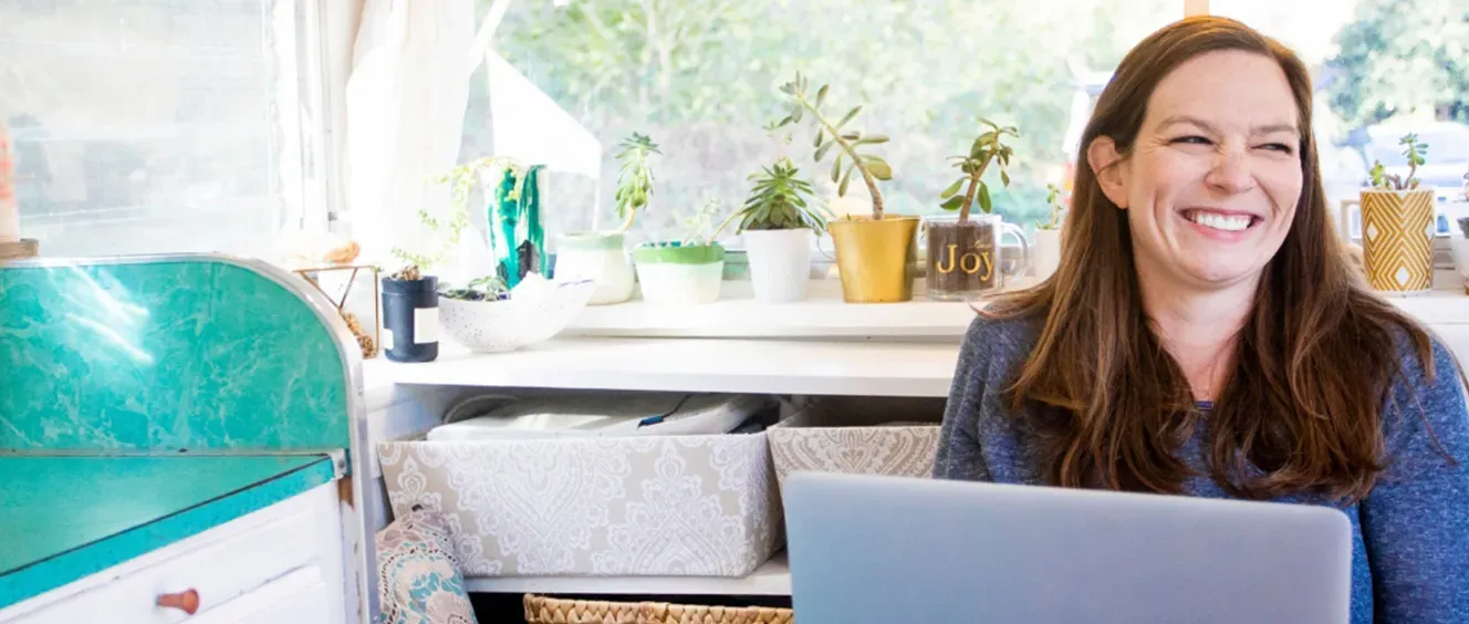 Woman on laptop smiling