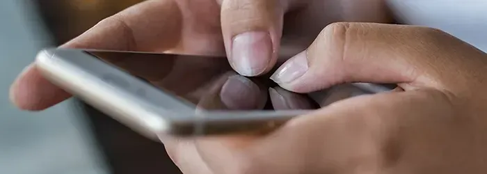Person typing on mobile phone