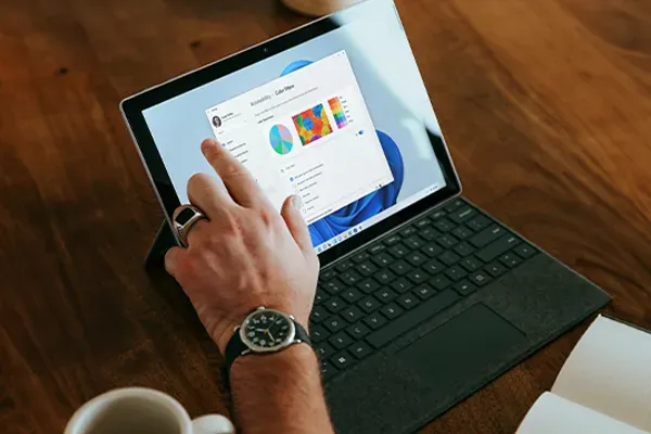 Man's left hand touching tablet