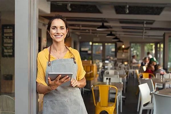 Woman smiling while holding tablet