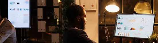 Man looking at a computer monitor with a light on