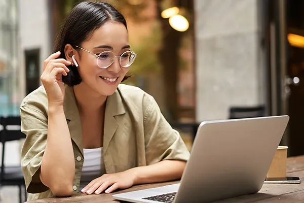 Woman with glasses looking at laptop
