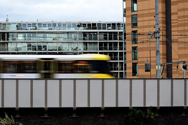 Tram travelling fast along a bridge