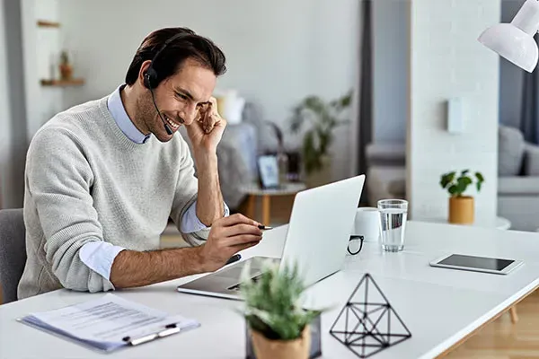 Man making a SIP trunk call on a headset at home