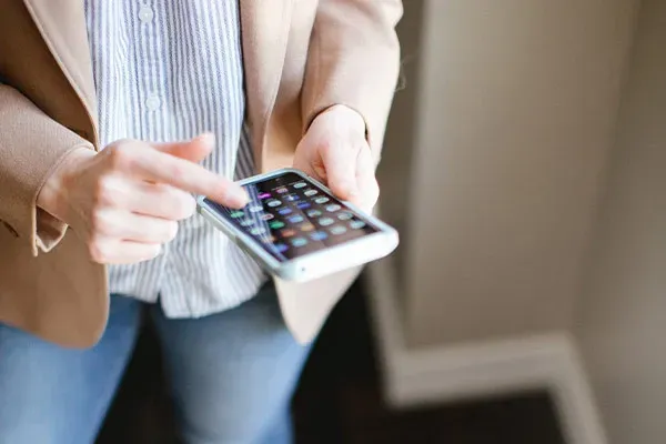 Woman scrolling through work apps on a mobile phone