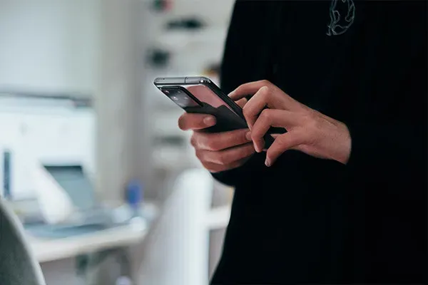 Person scrolling on business mobile phone