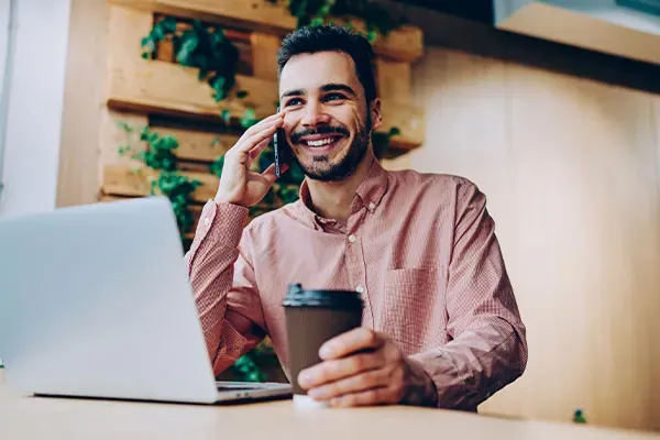 Man making a call on a mobile phone in a coffee shop