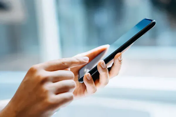 Woman using remotely managed business mobile handset