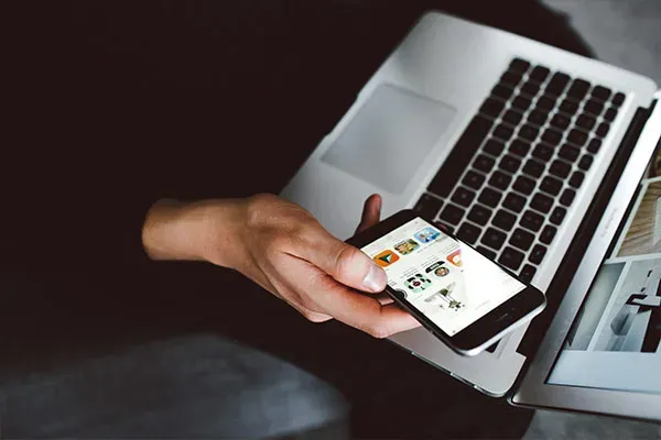 Business woman using mobile phone and laptop