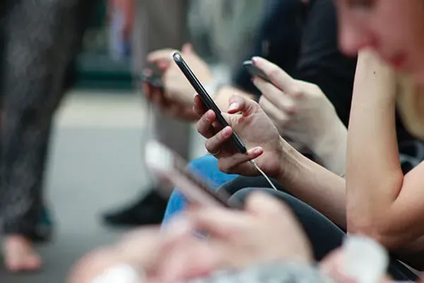 Line of people looking at phone