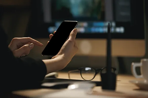 Person holding phone in their right hand