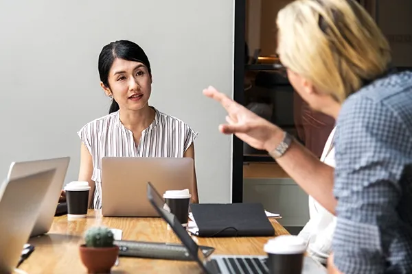 People with laptops in a meeting room