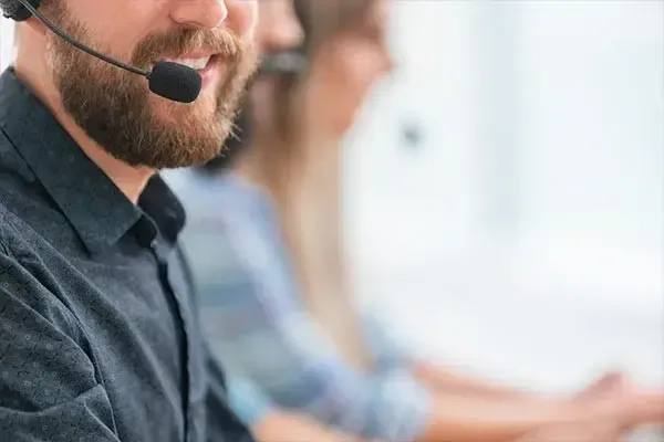 Man with a headset on answering a call