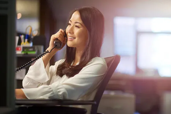 Woman using Ericsson-LG phone system