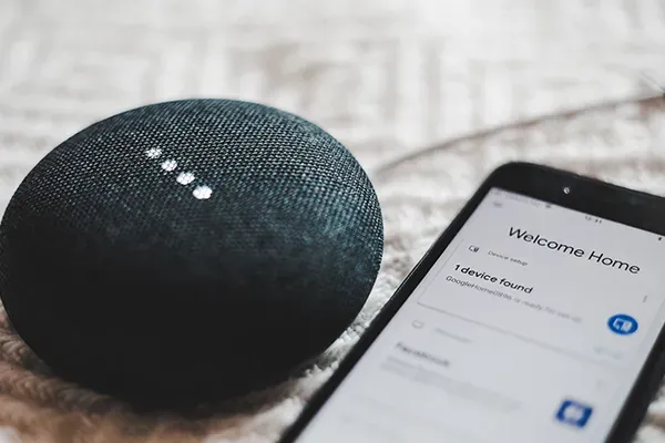 Google Nest Mini next to a mobile phone