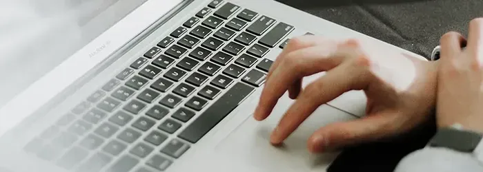 Person using mousepad on laptop with right hand