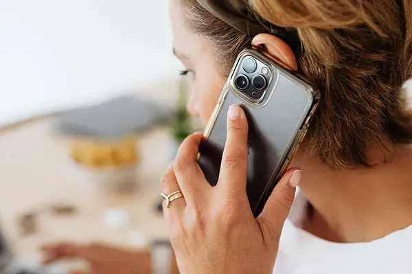 Woman making a call on a new iphone