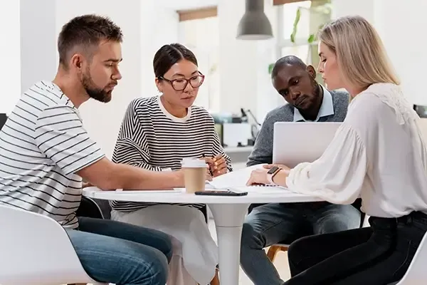 Group of people discussing ideas around a table