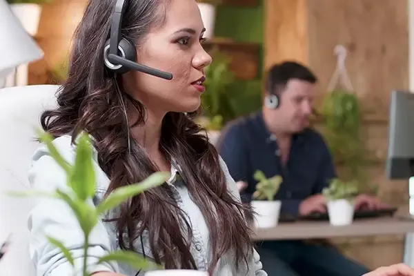 Woman in foreground with headset on