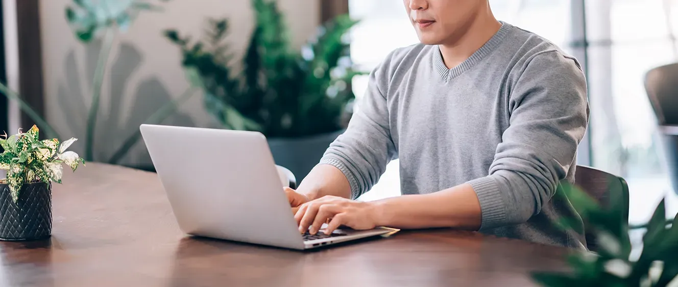 Man typing on a laptop