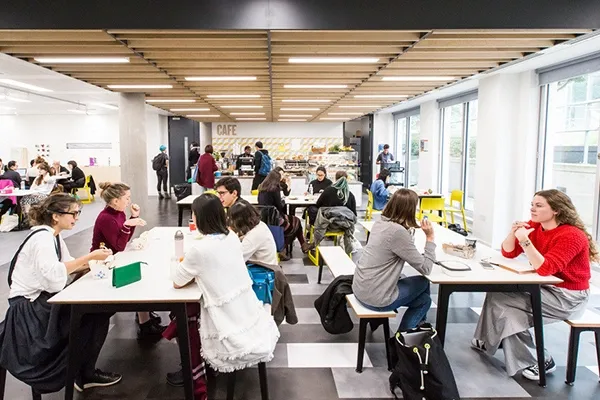 Students sitting down in a room talking to each other